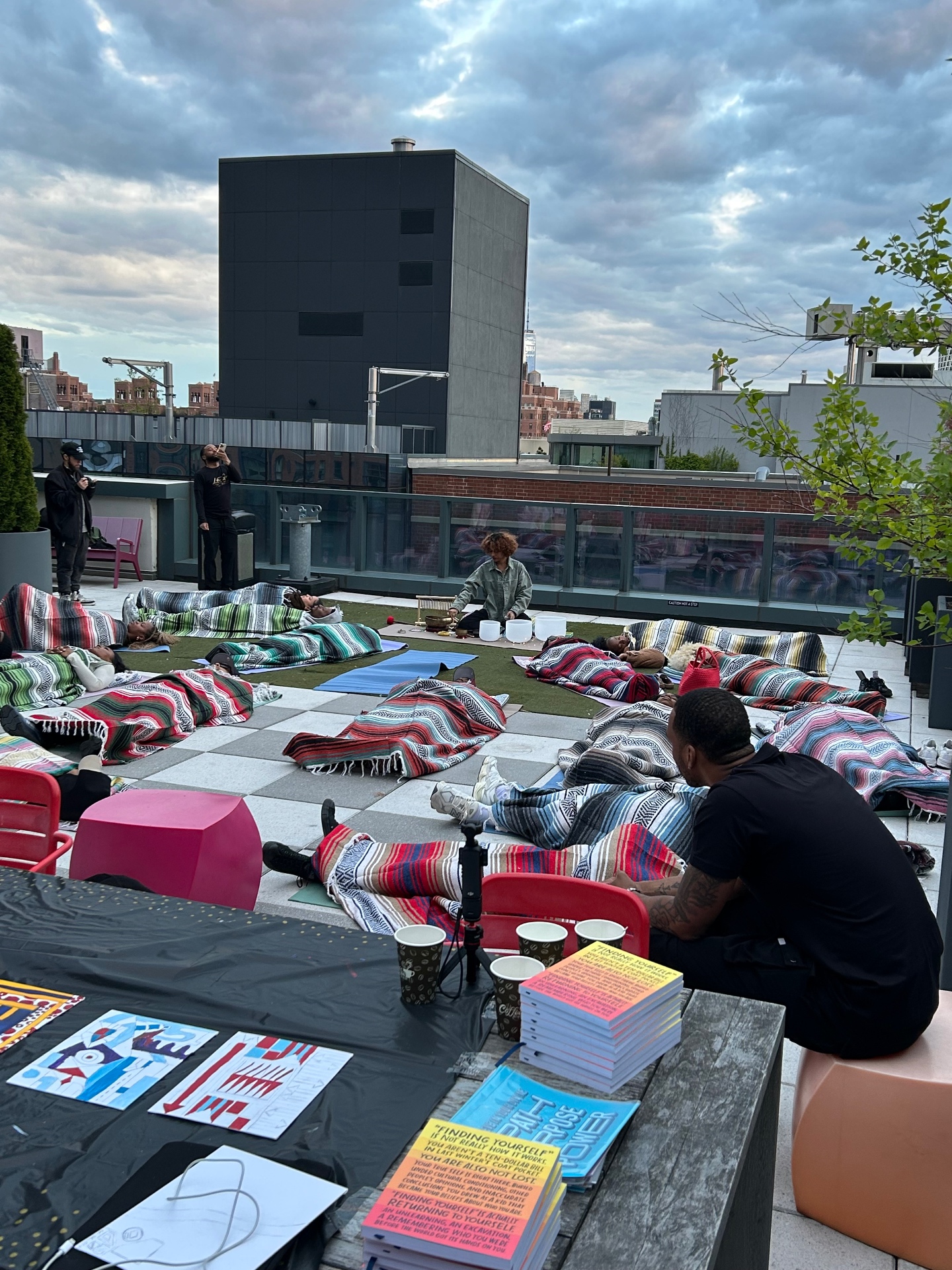 Sound healing session with attendees resting on blankets at sunset